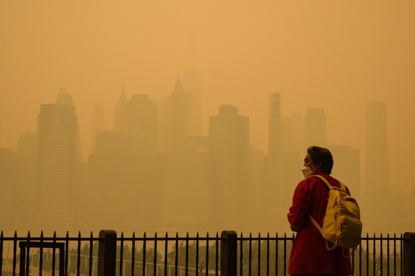 A person with a mask walking in haze