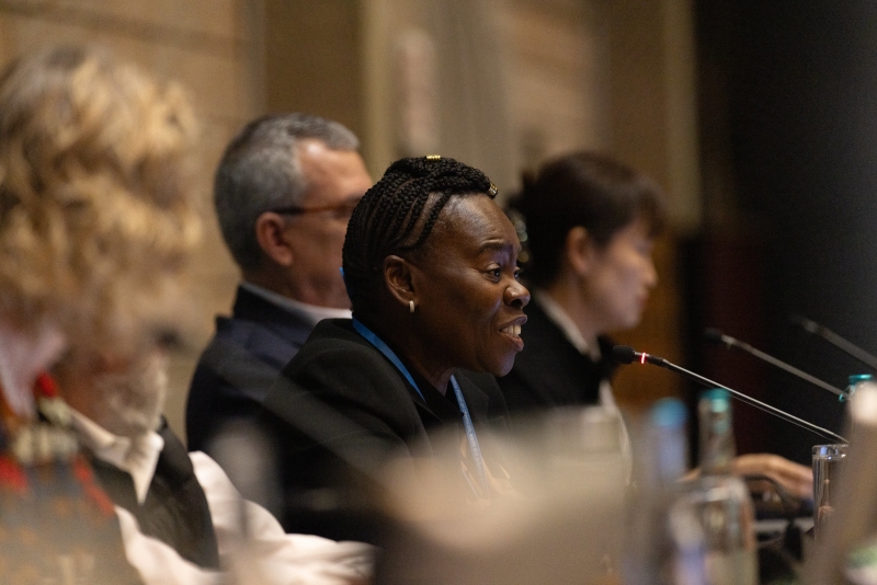 A woman speaking from a dais.