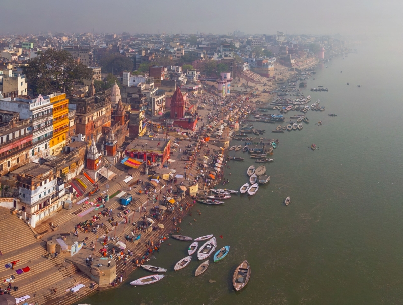 An aerial view of a river filled with boats 