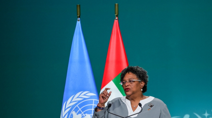 A woman speaking at a podium.